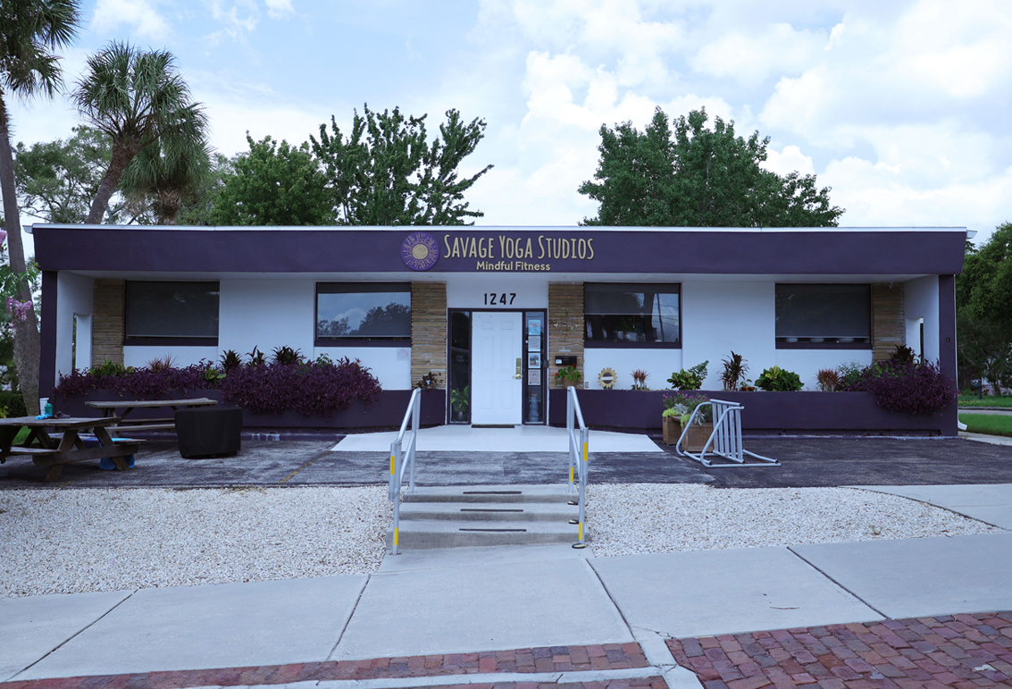 This image is an exterior photograph of a commercial office building located at 1247 Florida Avenue, Palm Harbor Florida